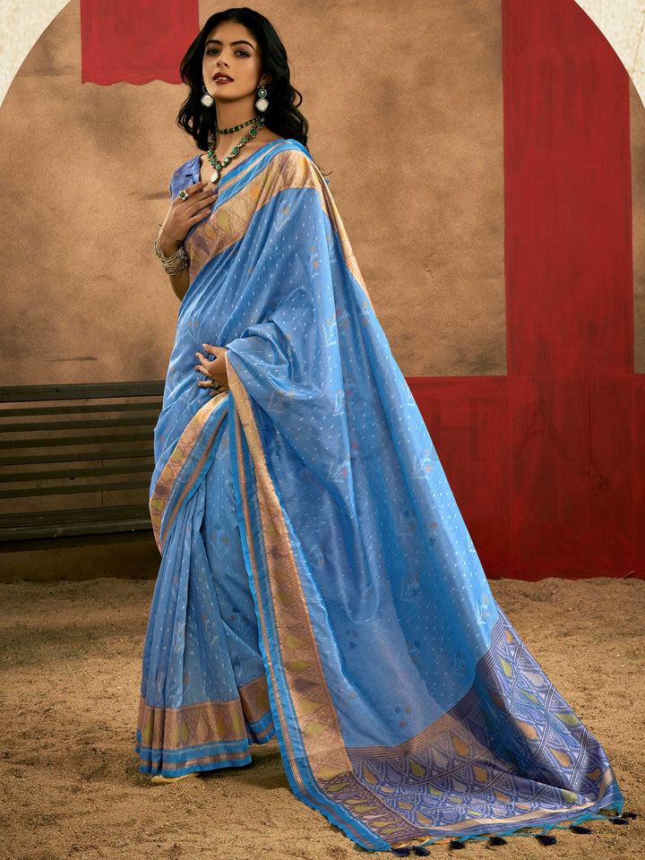 Sky Blue–Periwinkle Blue Banarasi silk saree with Patola-inspired design and rich zari border, styled for wedding glamour and traditional elegance. Sky Blue–Periwinkle Blue Banarasi silk saree with Patola-inspired design and rich zari border, styled for wedding glamour and traditional elegance..