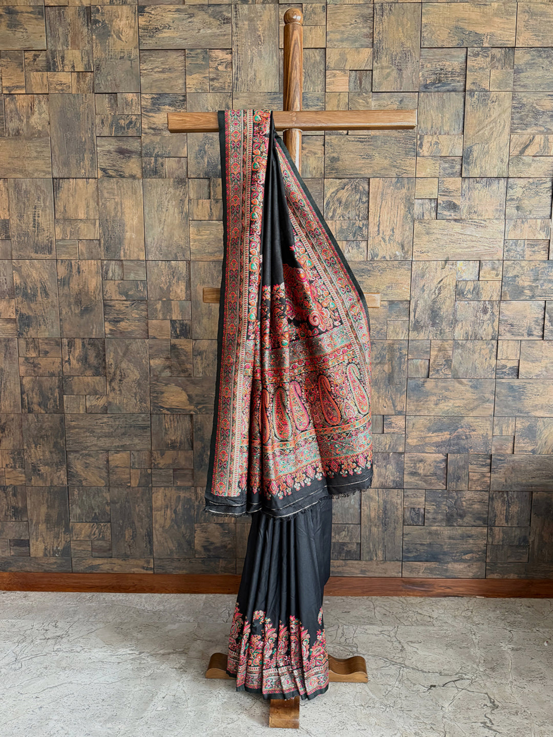 Luxurious black Pashmina raw silk saree featuring intricate embossed thread work, perfect for formal and festive occasions.