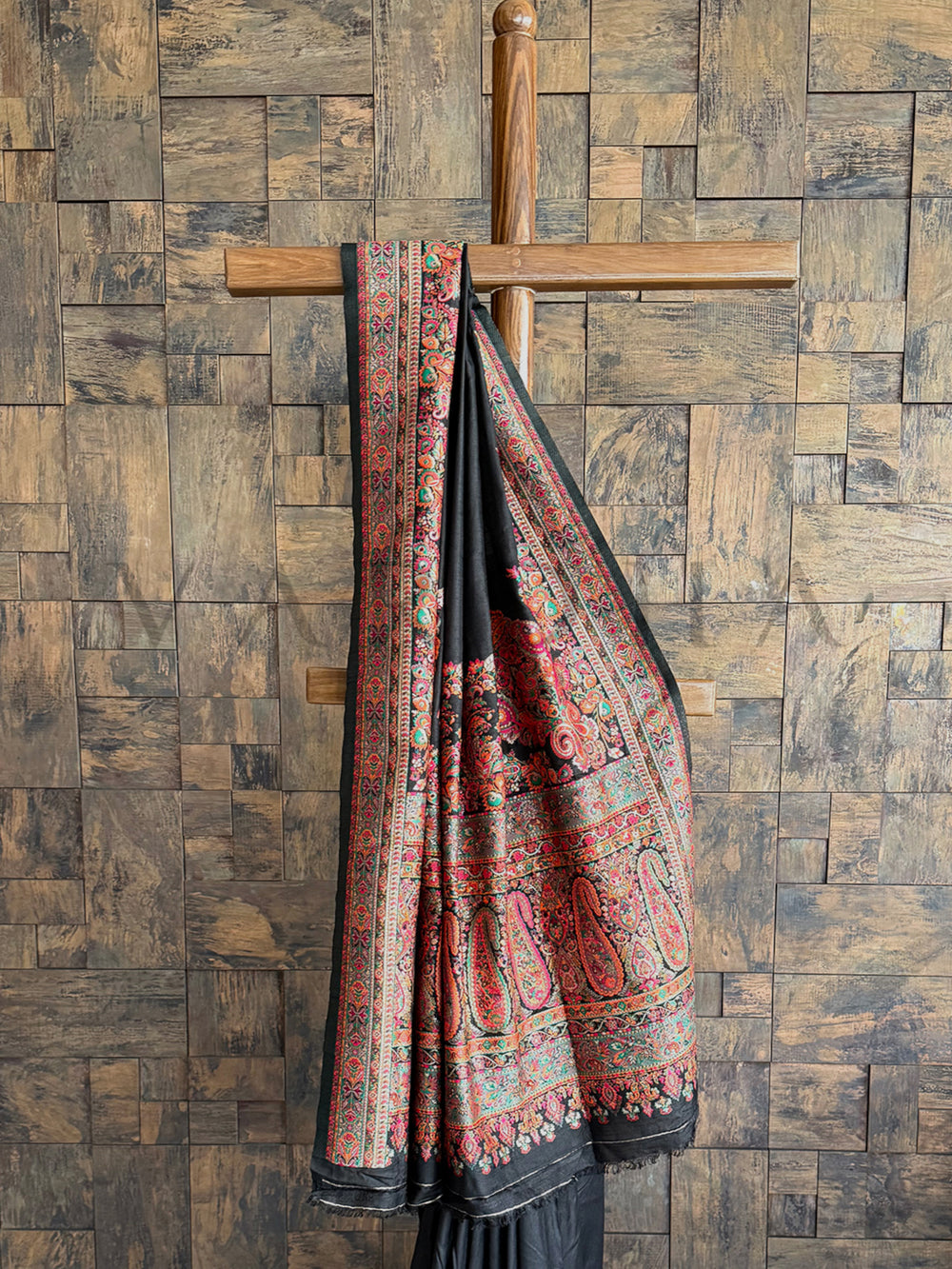 Elegant black raw silk saree with a rich Pashmina texture and delicate thread embroidery, offering timeless beauty.