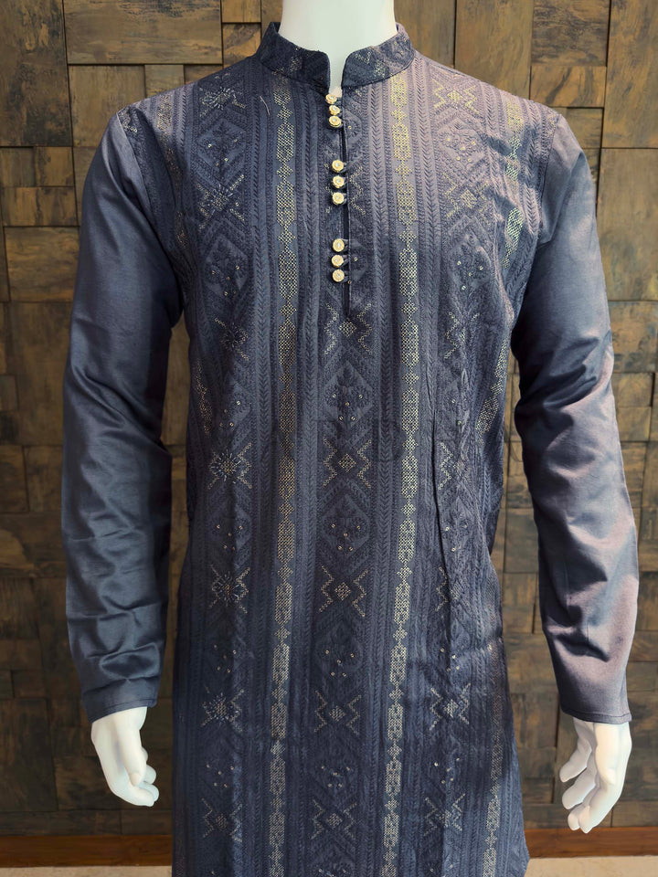 Traditional patterned kurta on a mannequin against a wooden background Front panel of men’s kurta showing geometric jacquard stripes with scattered sequin accents on smooth viscose fabric for celebrations and functions.