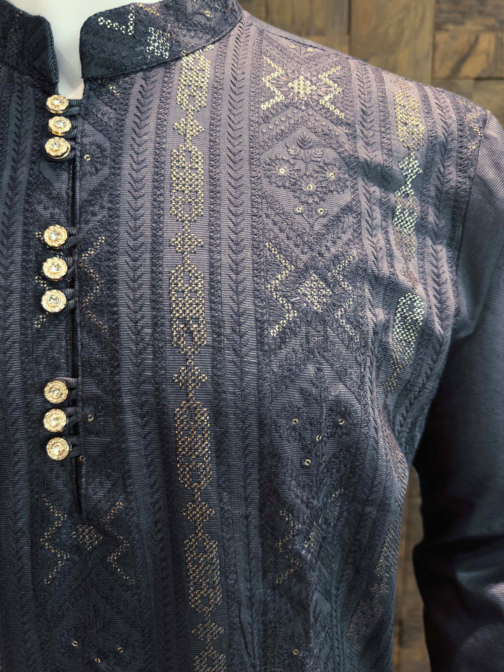 Close-up of a dark blue embroidered garment with gold buttons and patterns. Side view of charcoal grey festive kurta with full sleeves, refined collar, and elegant woven texture suitable for pooja and evening events.