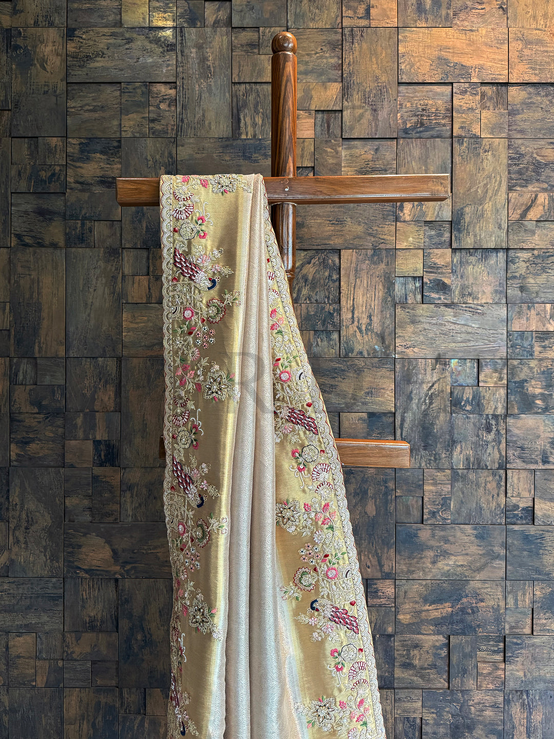 Luxury chiku saree with glowing golden undertones and intricate hand embroidery