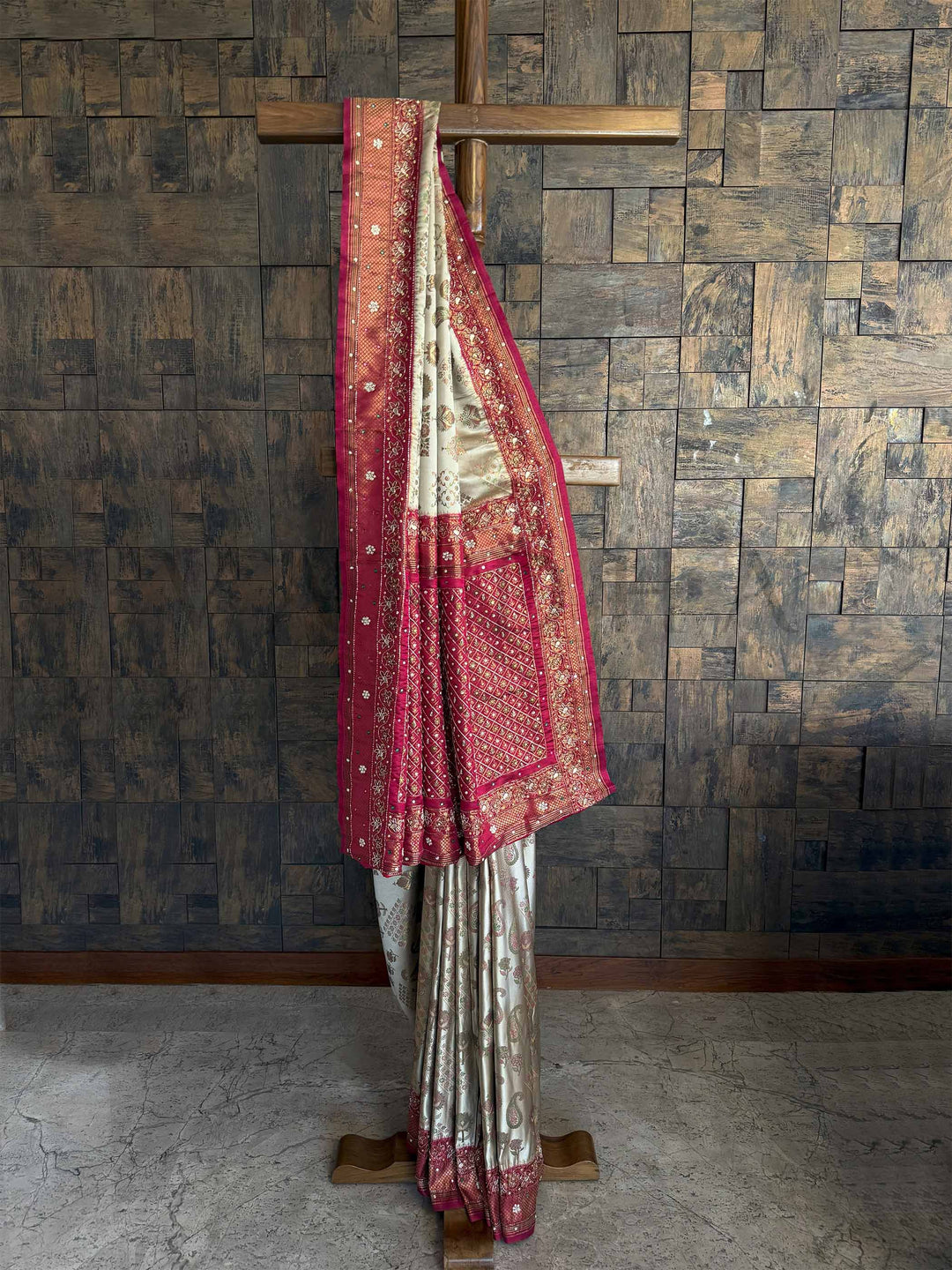 A stunning Cream Wine Kalamkari Silk Saree featuring intricate handwoven zari work, delicate floral motifs, and a rich silk texture. The saree is paired with a matching blouse, making it an elegant choice for weddings and festive occasions.