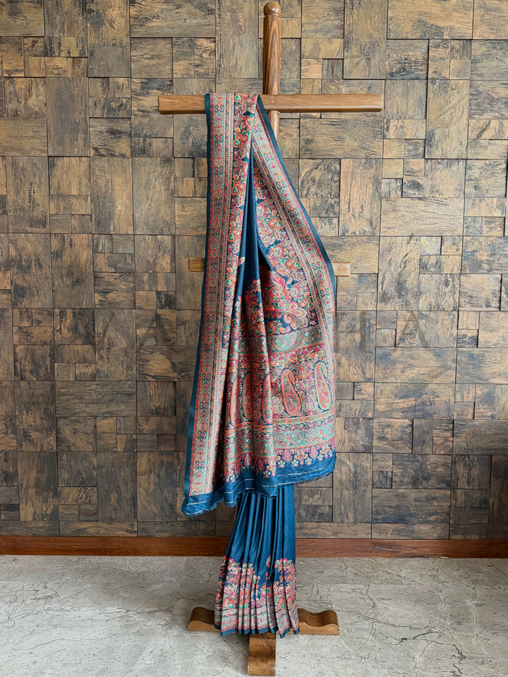 Sophisticated denim blue Pashmina raw silk saree featuring delicate embossed thread work for a refined and graceful appeal.