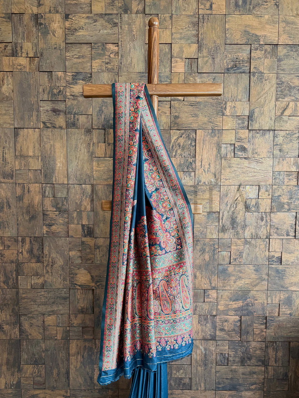 Luxurious denim blue saree in Pashmina raw silk, adorned with exquisite thread embroidery and embossed detailing.