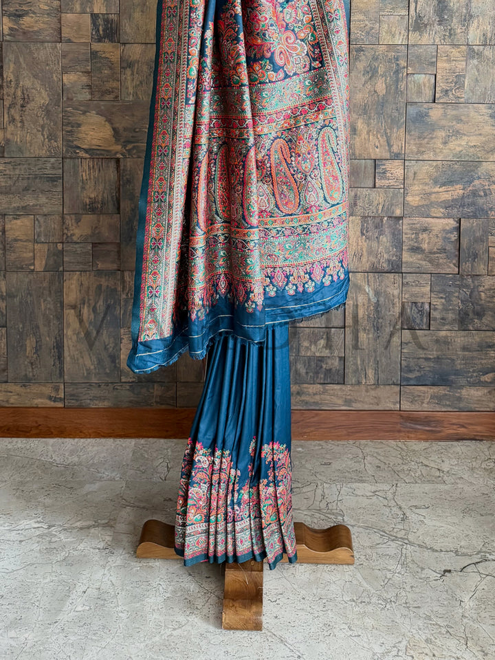 Graceful denim blue Pashmina raw silk saree with artisanal embossed thread work, blending tradition with modern elegance.