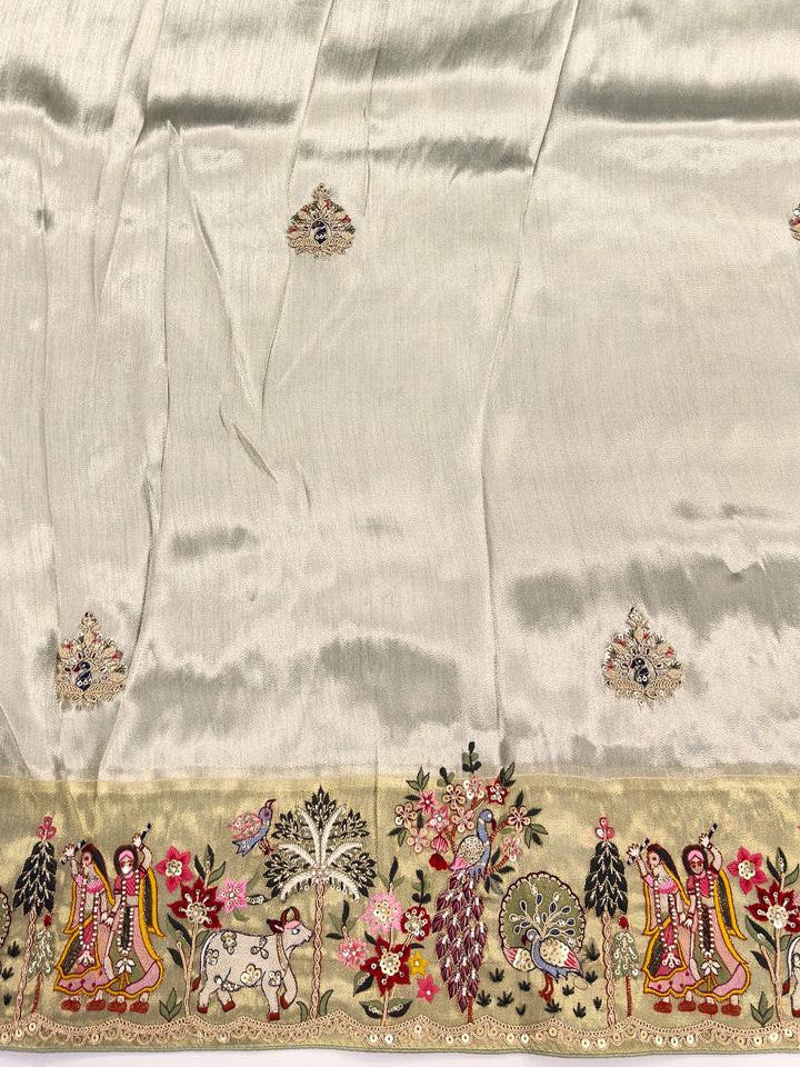 Decorative fabric with intricate patterns and embroidery on a beige background