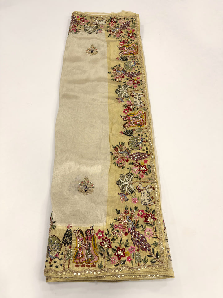 Embroidered fabric with floral and paisley patterns on a beige background