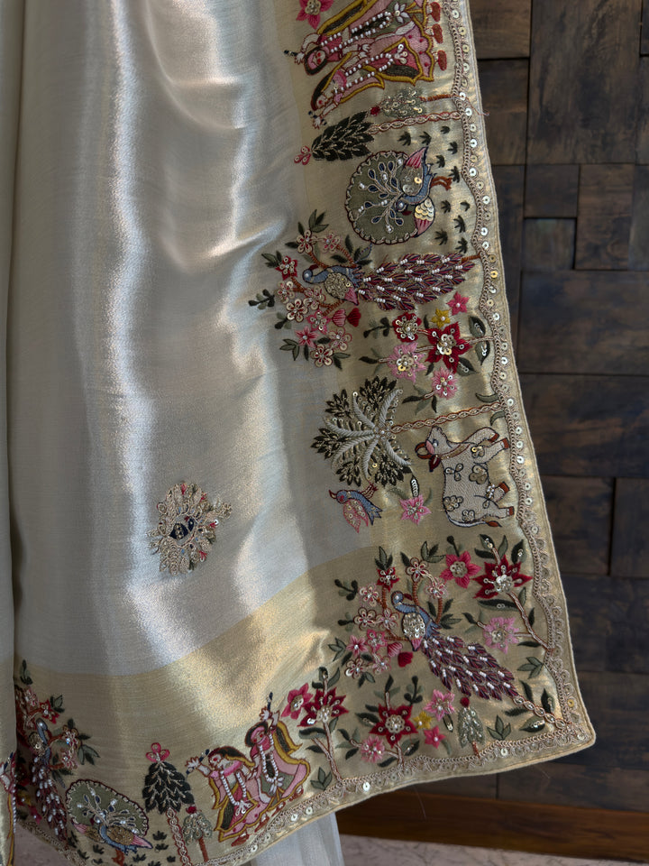 Decorative fabric with intricate embroidery on a wooden surface