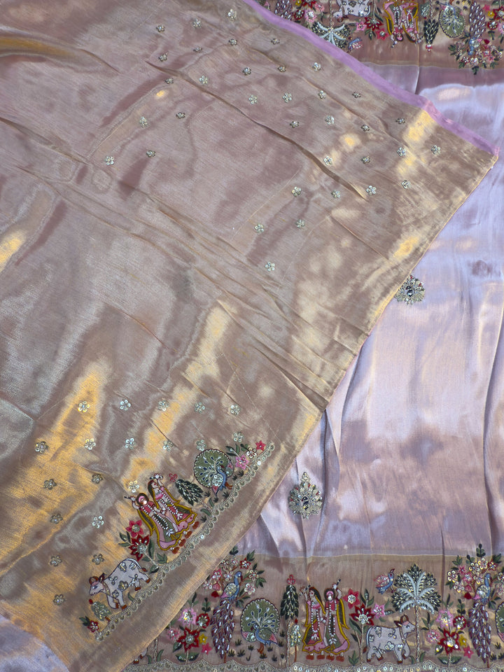 Decorative fabric with intricate patterns and embroidery on a pink background