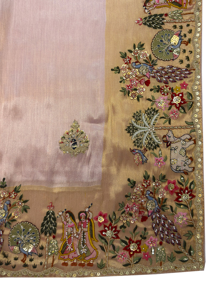 Decorative fabric with intricate embroidery featuring flowers, peacocks, and people in a garden setting.