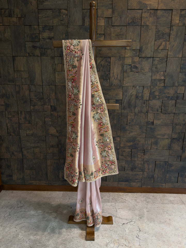 Traditional outfit with floral embroidery on a wooden stand against a textured wall.
