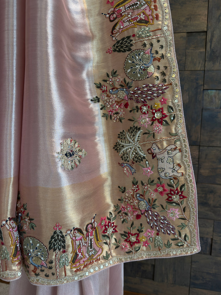 Decorative fabric with intricate embroidery and embellishments on a wooden surface