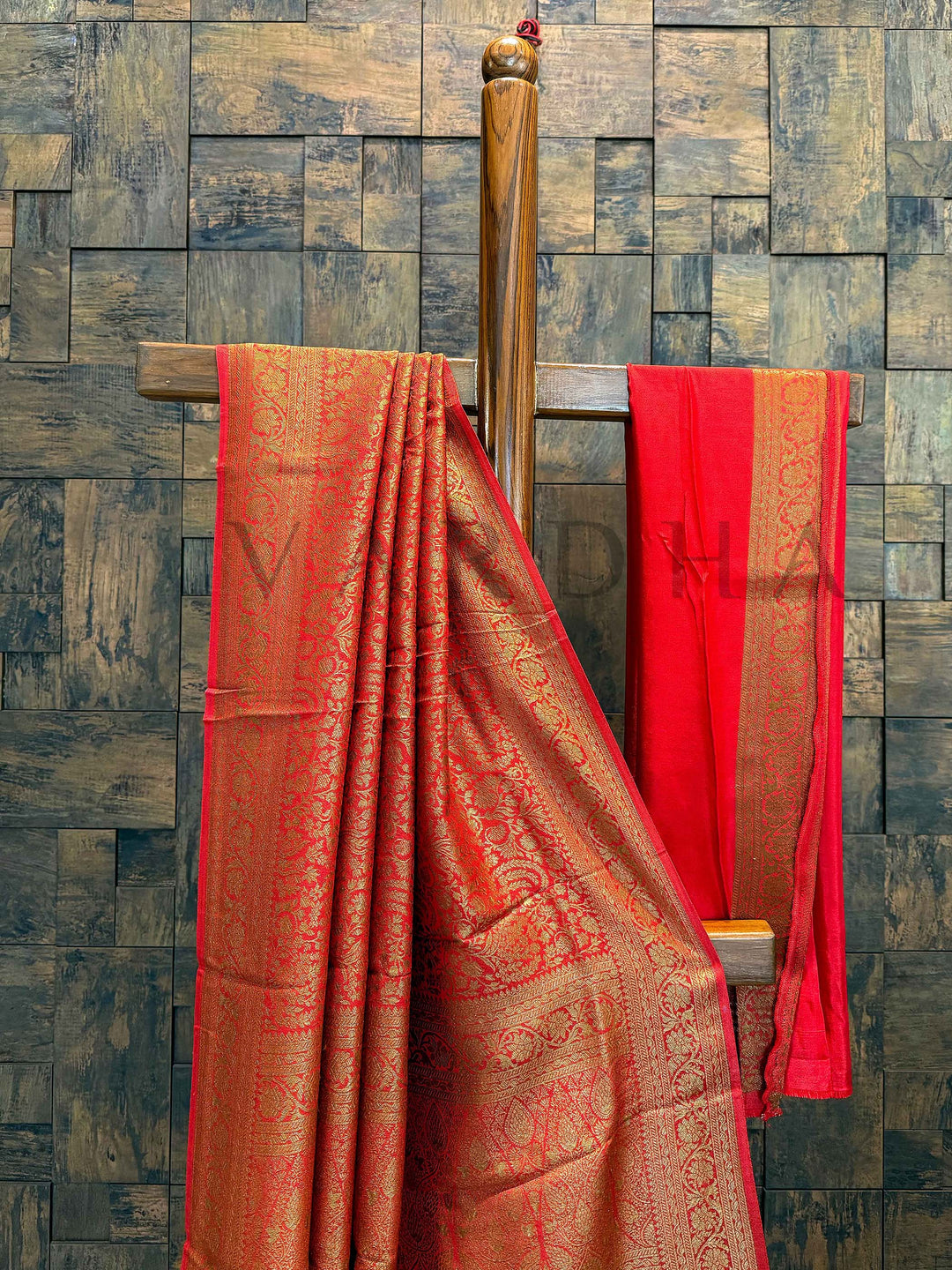 Red blouse with matching zari border placed beside saree, highlighting contrast pairing Border detail showing refined gold weaving and smooth selvage finish of the saree