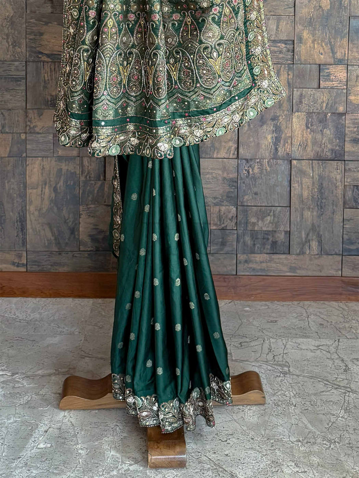 Elegant emerald green Banarasi Jamawar saree in satin silk, adorned with intricate hand embroidery for a timeless appeal.