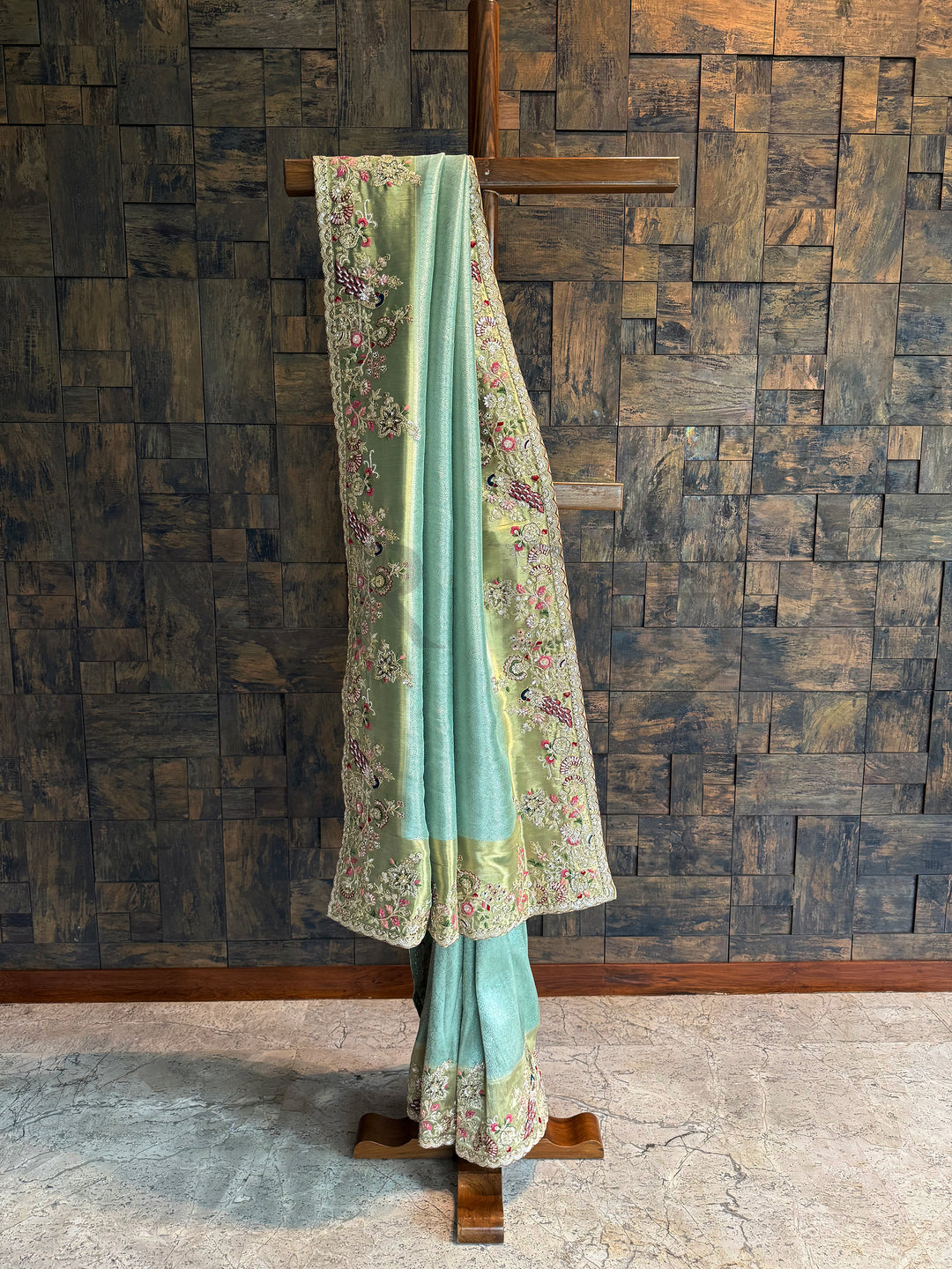 Firozi Kanjivaram tissue silk saree with zari weaving, scalloped embroidered border and peacock motifs.
