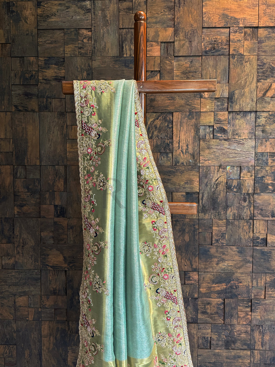 Aqua blue tissue silk saree featuring floral resham embroidery, sequins, and zari highlights.