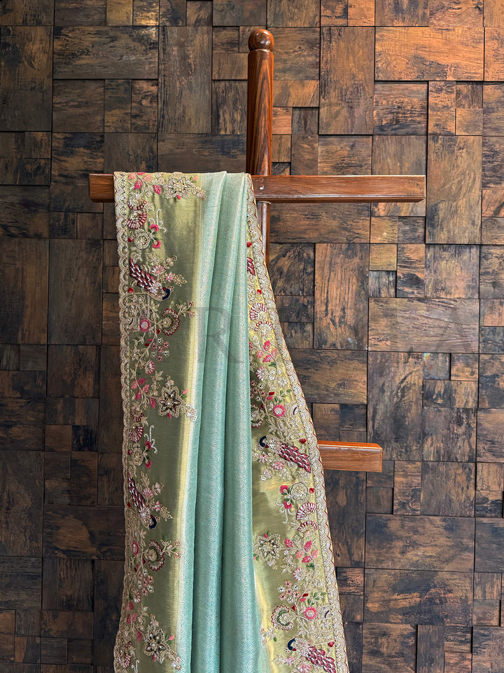 Elegant firozi silk saree in Kanjivaram tissue with gold undertones and embellished scalloped edge.