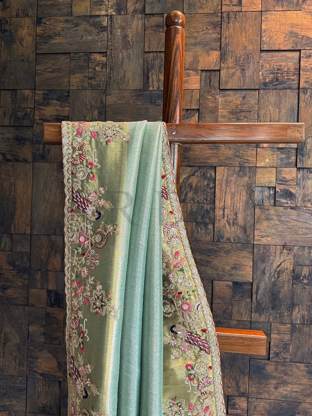 Festive aqua blue saree crafted in tissue silk with peacock embroidery and zari embellished pallu.