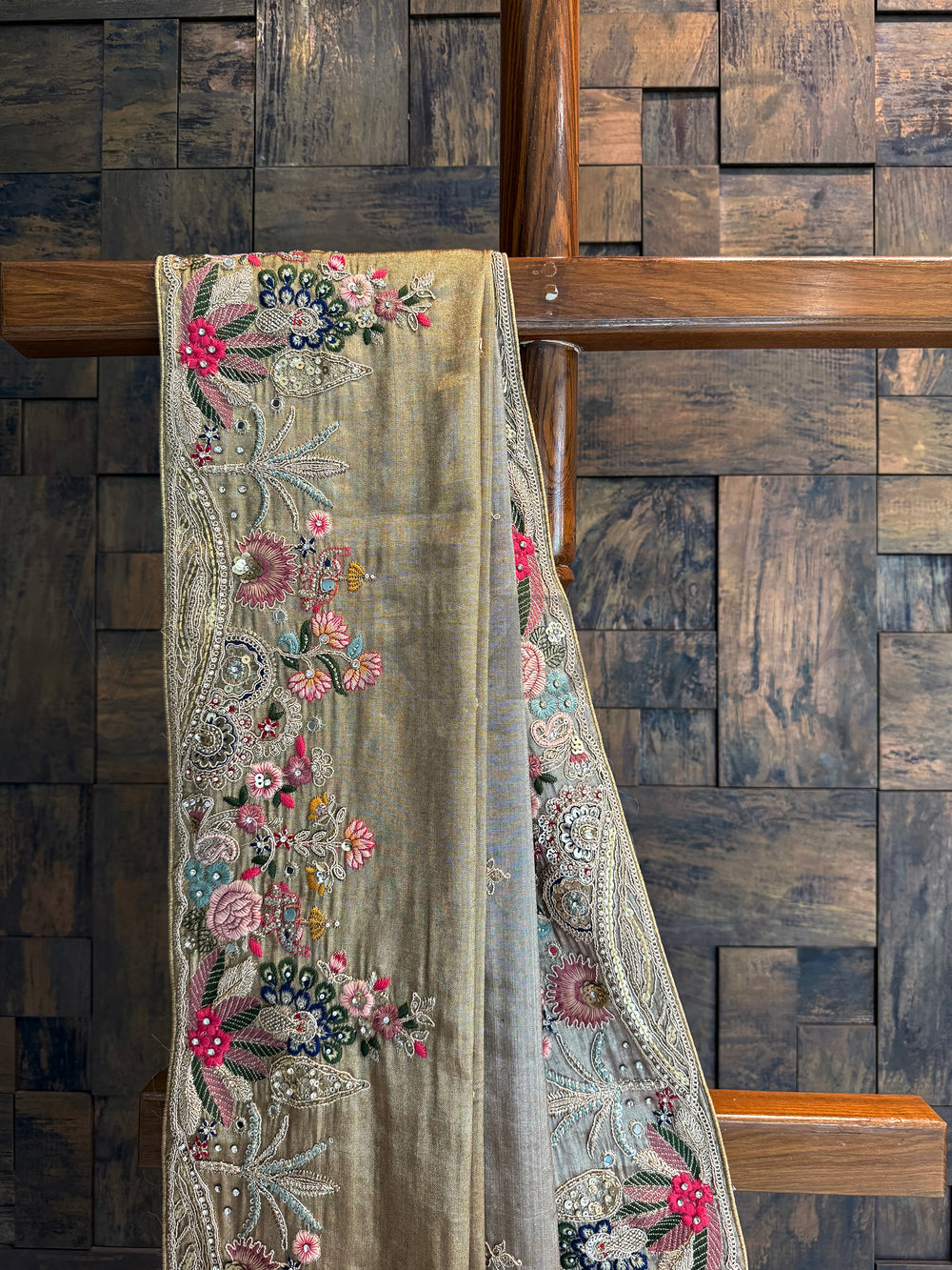 Close-up of floral embroidery with sequins, zari, and resham threads on golden Kanjivaram tissue saree.