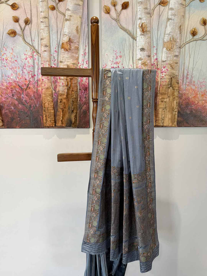 Elegant grey satin saree with Jamawar weaving, designed for weddings and celebrations, radiating timeless charm.