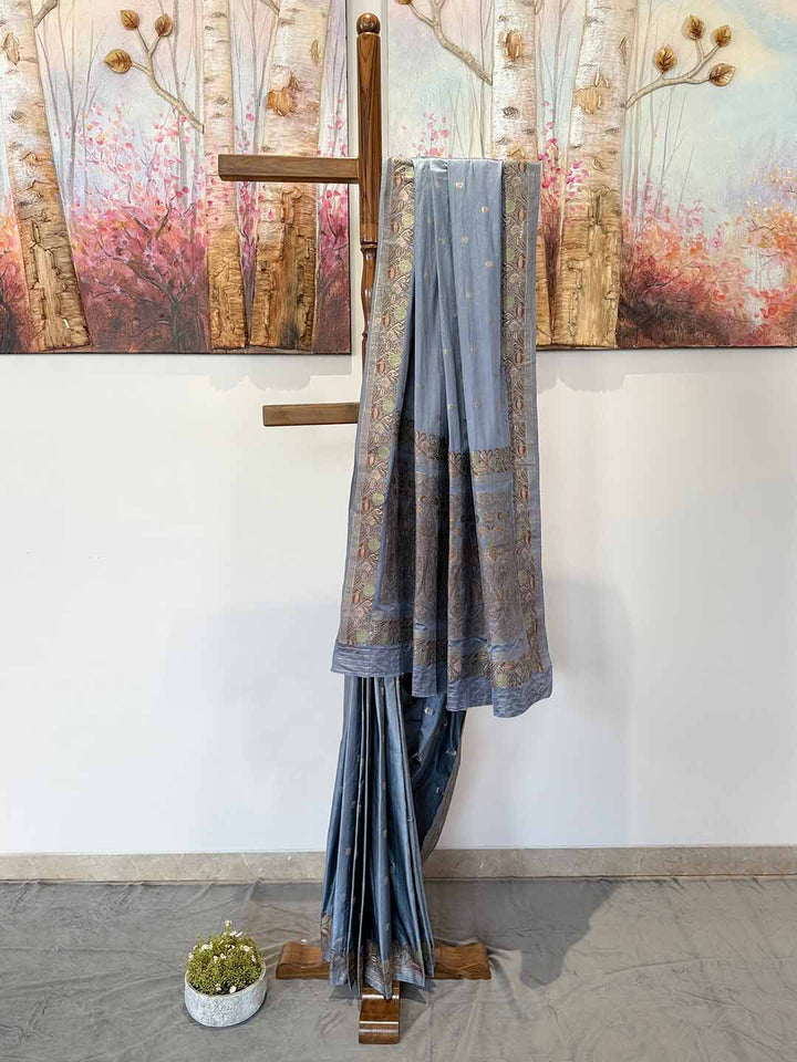 Sophisticated grey Jamawar satin saree, featuring detailed patterns, perfect for weddings and celebratory events.