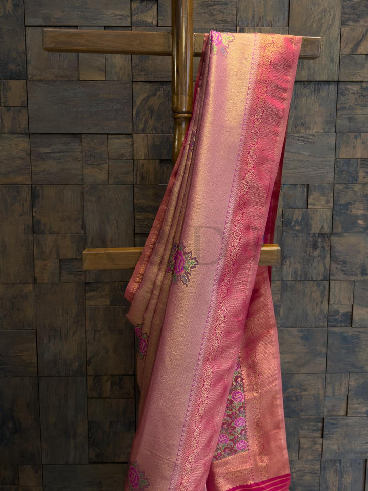 Soft art silk saree pleats in lac pink with zari accents, perfect for traditional festivities and wedding wear., Pallu showcasing colorful floral kalamkari artistry framed in luminous golden thread work