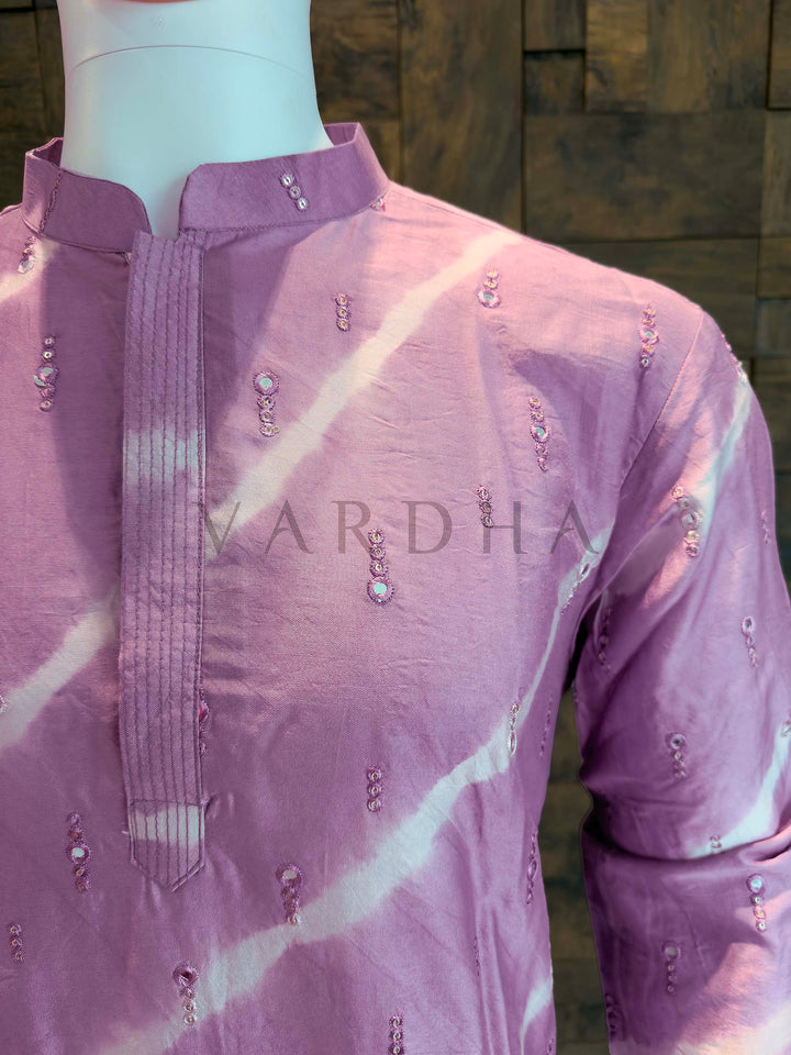Purple embroidered shirt on a mannequin with 'Vardha' branding. Angled shot emphasizing the slimming effect of diagonal bands, crisp collar construction and comfortable festive silhouette.
