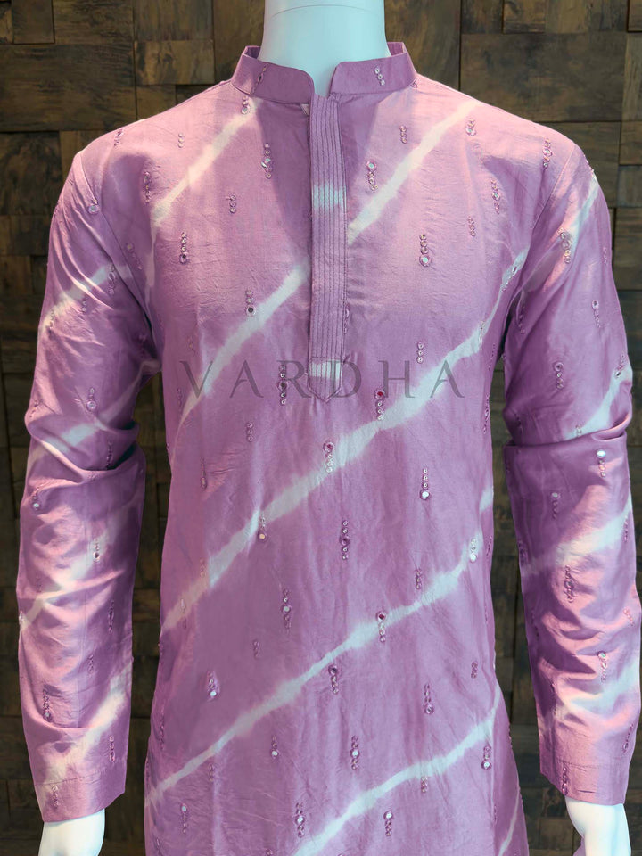 Purple kurta with white patterns on a mannequin against a wooden background