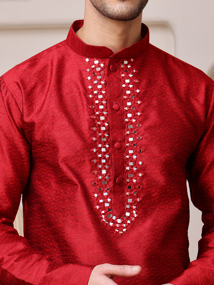Red kurta with intricate silver embroidery on a neutral background