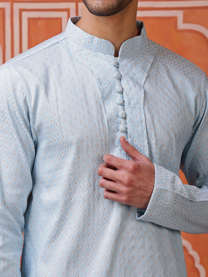 Full view of a model wearing a modern sky blue angrakha kurta with white pajamas