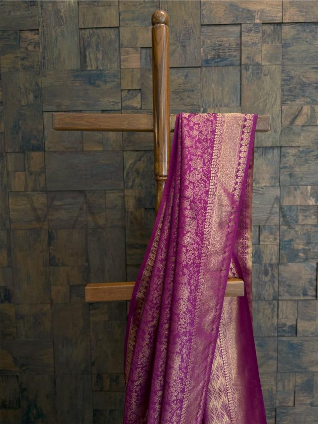 Detailed zari motifs featuring floral and peacock elements in gold thread on magenta silk kanjivaram saree for wedding occasions., Lower pleats of magenta kanjivaram saree with gold jacquard weave, ideal for traditional South Indian styling