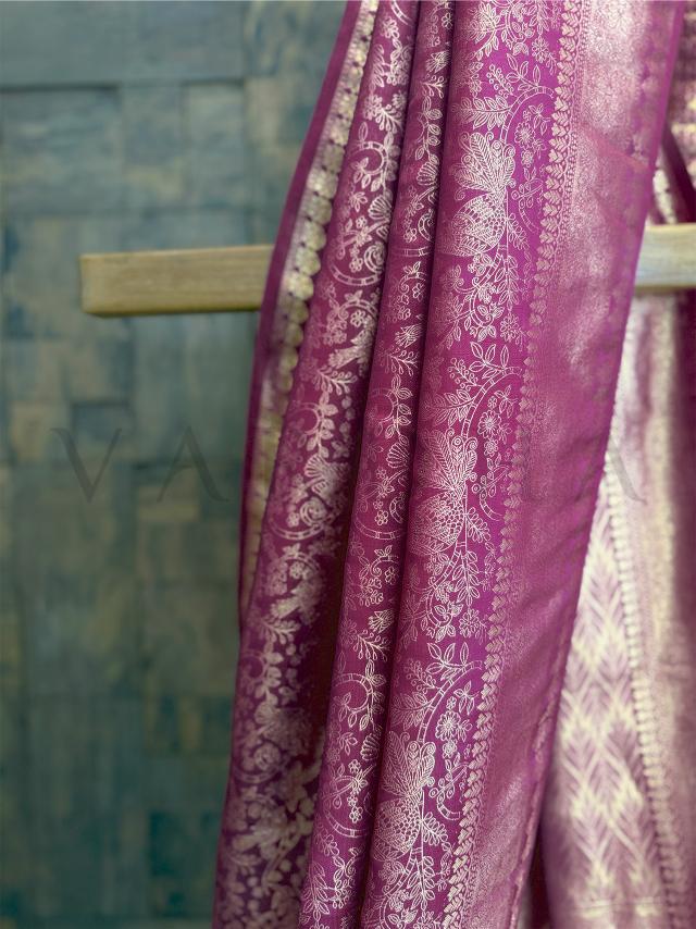 Flat lay of brocade blouse piece in matching magenta and gold zari work, unstitched and perfect for styling., Rich pallu end of magenta silk saree showcasing zari motifs and temple-style design, luxurious festive wear drape.