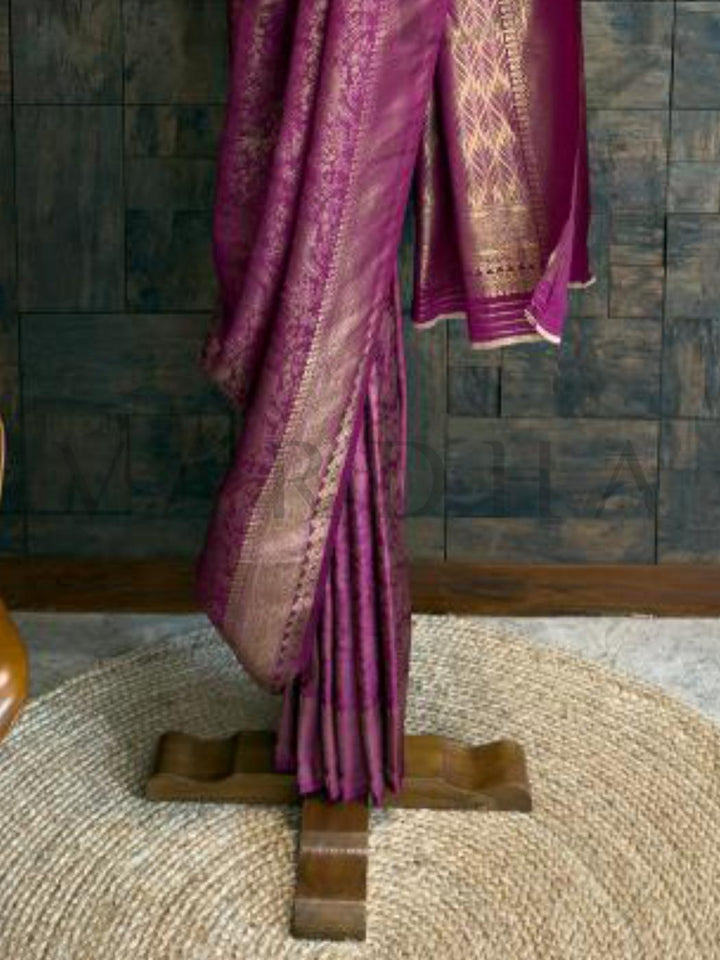 Elegant kanjivaram silk texture with shimmering gold zari embroidery, saree ideal for party and ethnic celebrations., Magenta kanjivaram silk saree draped on stand, showcasing gold zari floral detailing perfect for traditional functions.