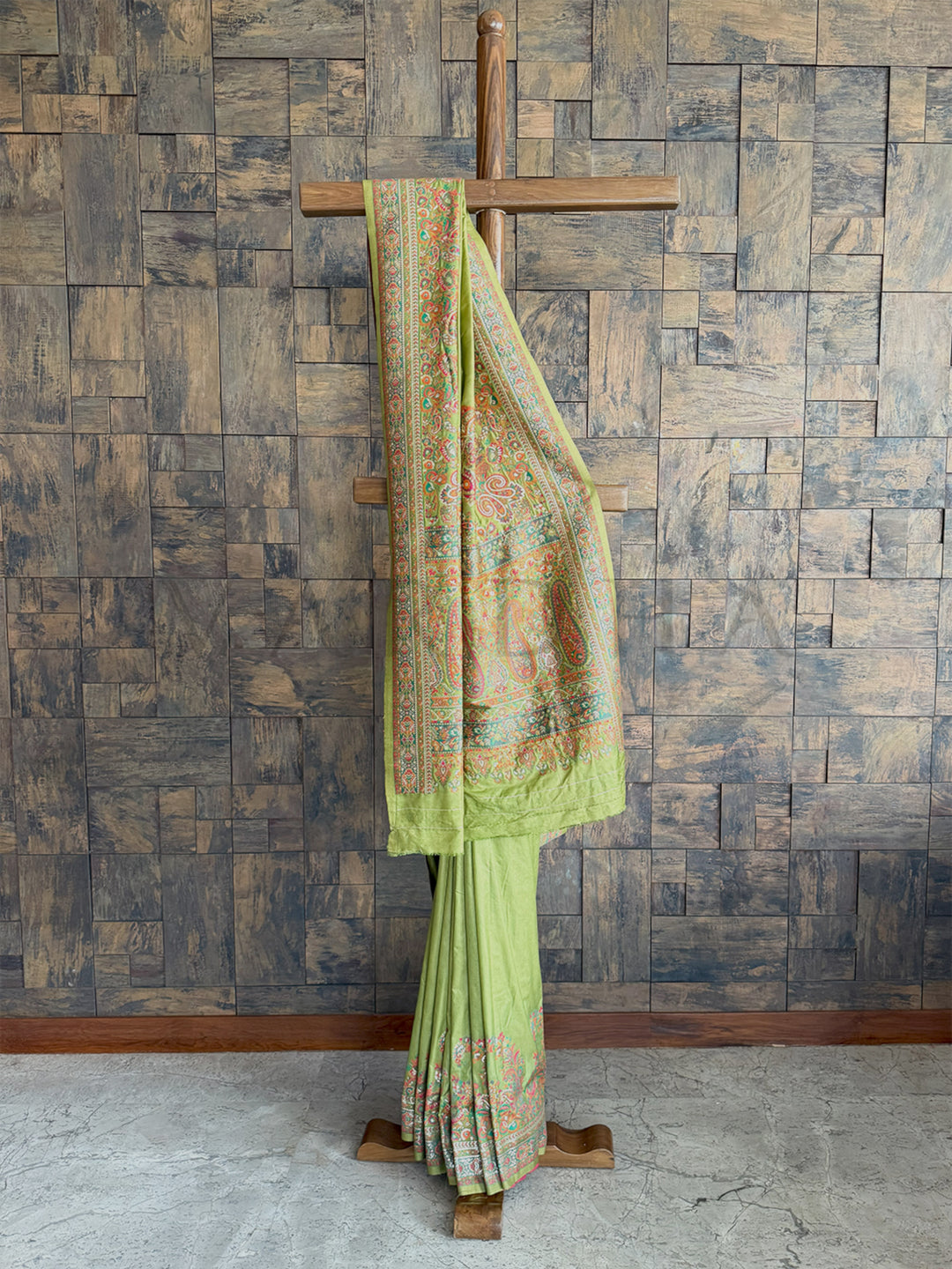 Luxurious mehendi green Pashmina raw silk saree featuring intricate embossed thread work for a regal and sophisticated look.