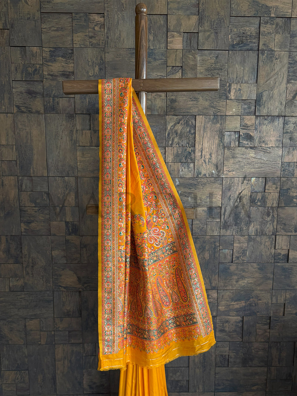 Luxurious mustard-yellow saree in Mustard-yellow raw silk saree with a soft Pashmina texture and exquisite embossed thread detailing, perfect for festive elegance.