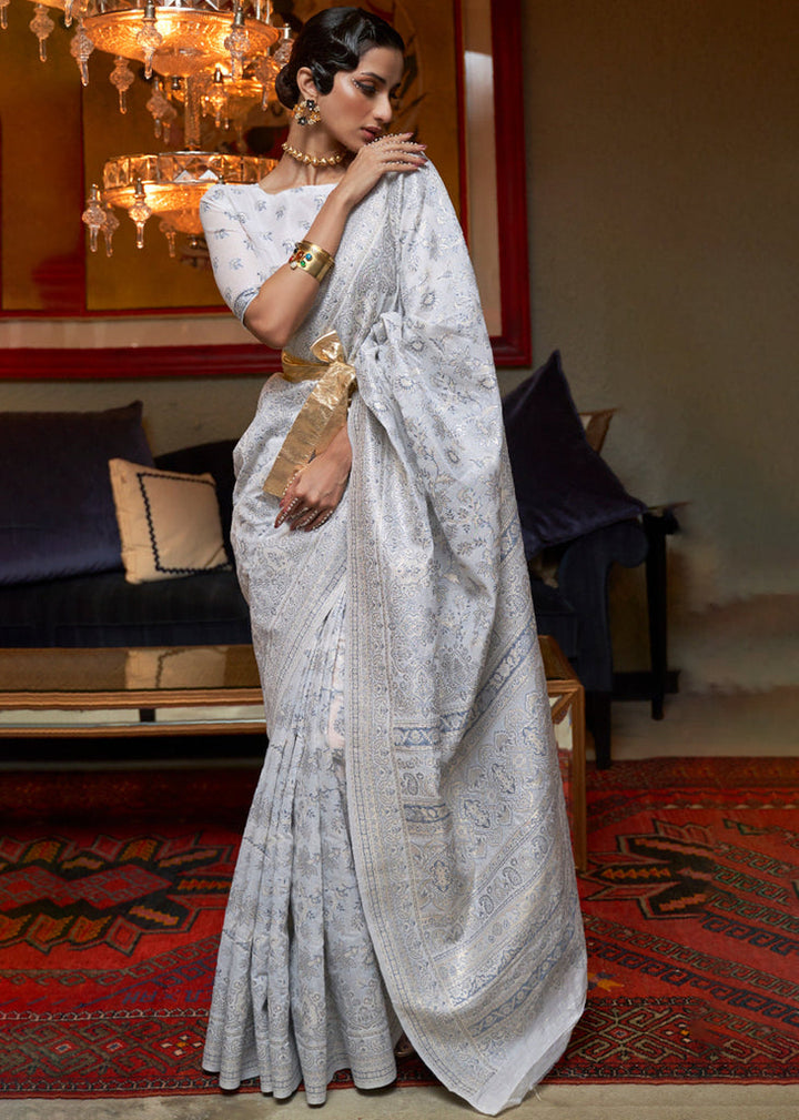 Off white Kashmiri modal silk saree with handloom weaving and floral woven design, perfect for traditional occasions.