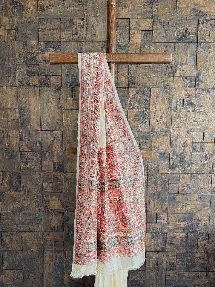 Classic off-white raw silk saree with delicate Pashmina texture and stunning embossed thread embroidery for an ethereal charm.