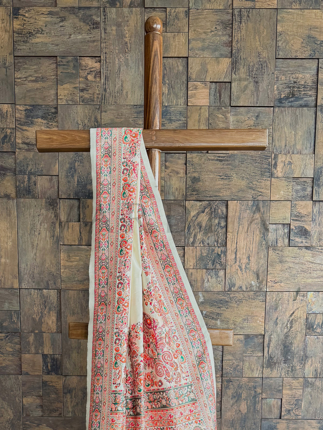 Off-white Pashmina raw silk saree with beautifully embossed thread work, exuding elegance and artisanal craftsmanship.