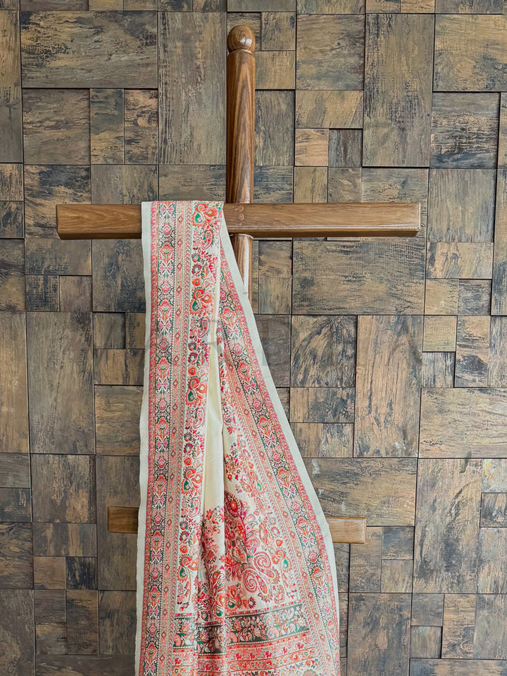 Off-white Pashmina raw silk saree with beautifully embossed thread work, exuding elegance and artisanal craftsmanship.