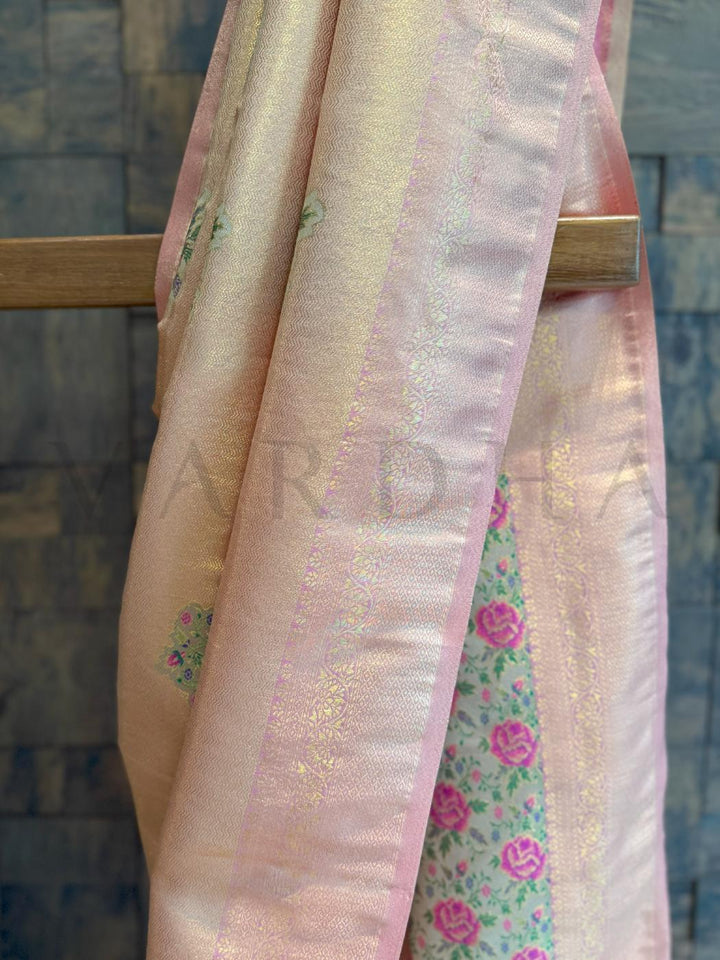 Pleated zone of saree with delicate sheen and light zari embroidery work for heritage charm., Blouse piece in cream with peach woven edge ideal for ethnic styling and cultural dressing