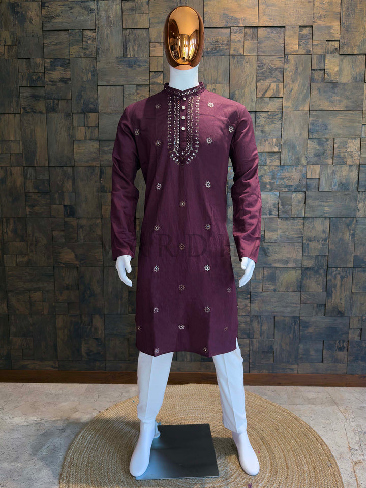 Plum Wine viscose men’s kurta with mandarin collar, mirror work placket and scattered star buti embroidery, styled on a mannequin with white churidar for festive occasions.