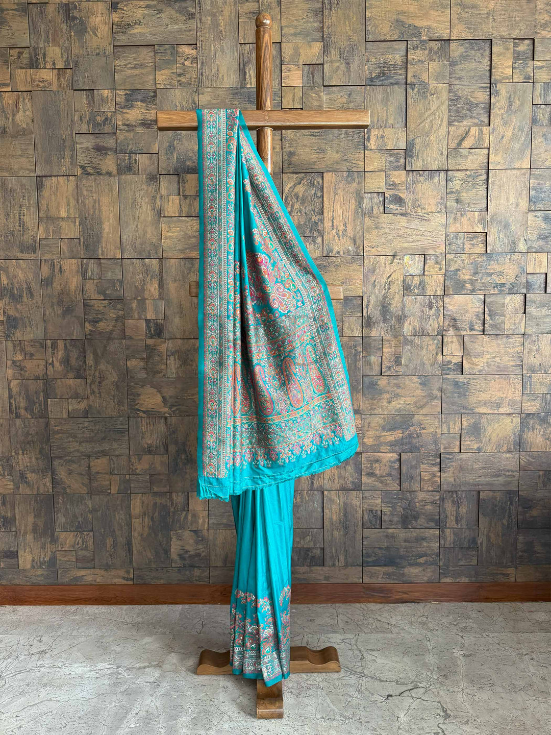 Graceful Rama blue Pashmina raw silk saree adorned with intricate embossed thread work, perfect for an elegant and timeless look