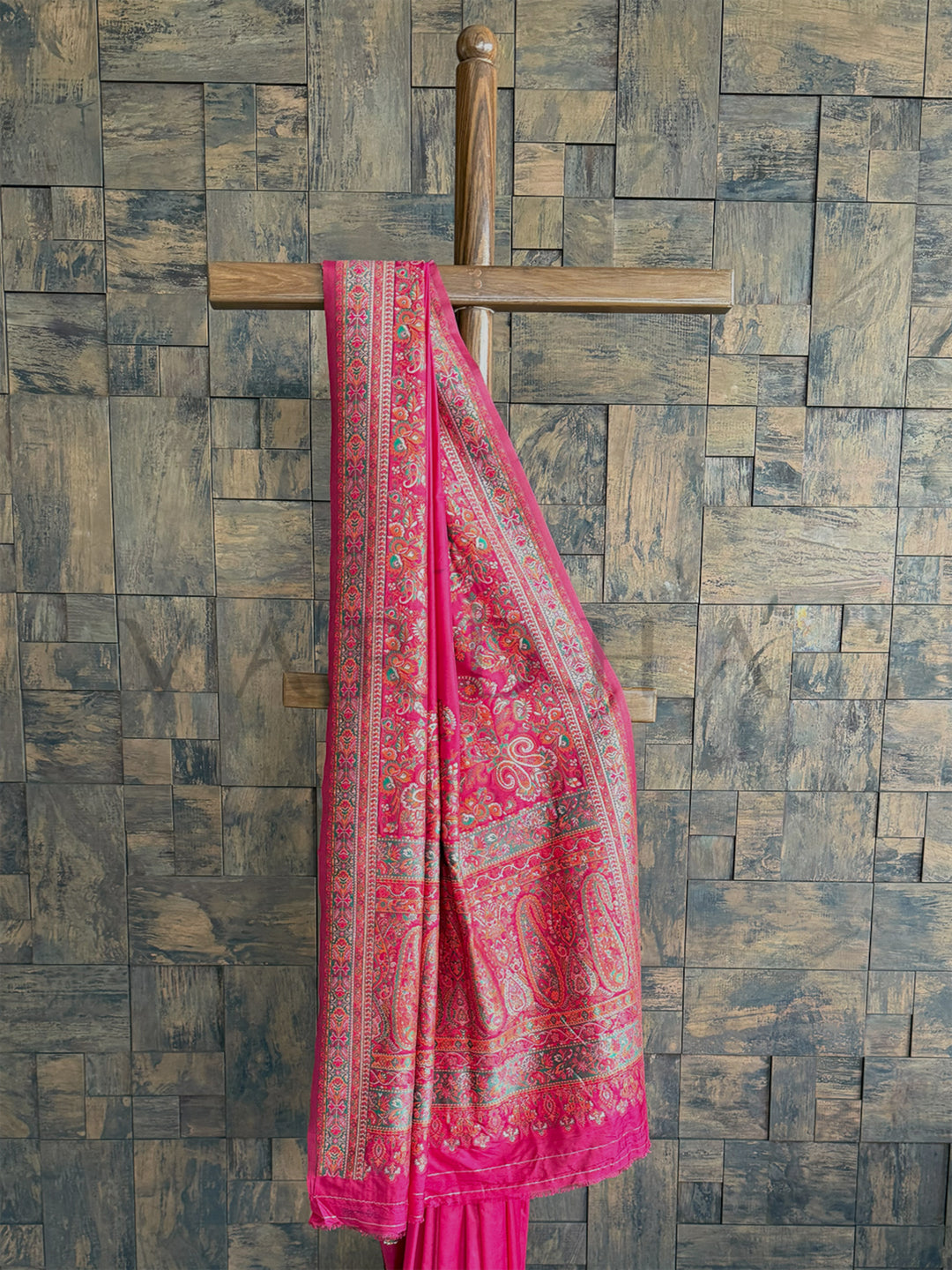Elegant Rani Pink raw silk saree with exquisite Pashmina texture and detailed embossed thread embroidery.