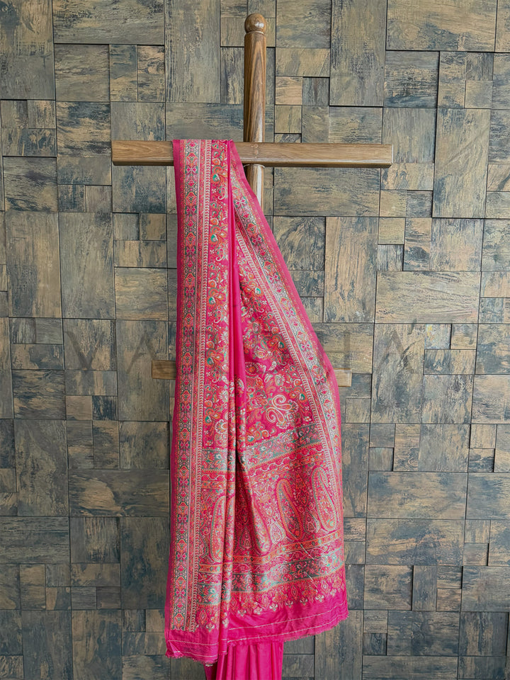 Elegant Rani Pink raw silk saree with exquisite Pashmina texture and detailed embossed thread embroidery.