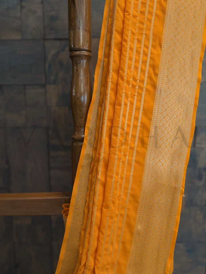Yellow saree texture captured to reflect its featherlight drape and subtle zari glow under natural light., Matching blouse piece in yellow georgette with zari border, ready to be styled for ethnic elegance and ease