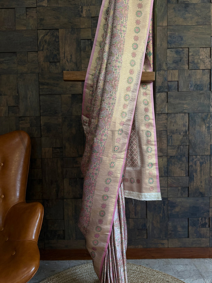 Designer saree in white and pink with detailed Kalamkari work and woven floral motifs. White brocade saree featuring contrast pink pallu and traditional wedding charm.