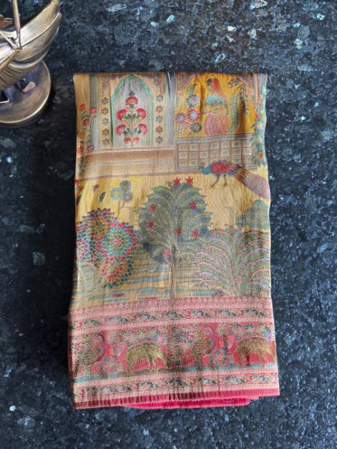 Yellow Katan silk saree with jacquard weaving and pink accents, featuring kalamkari zari patterns of heritage importance