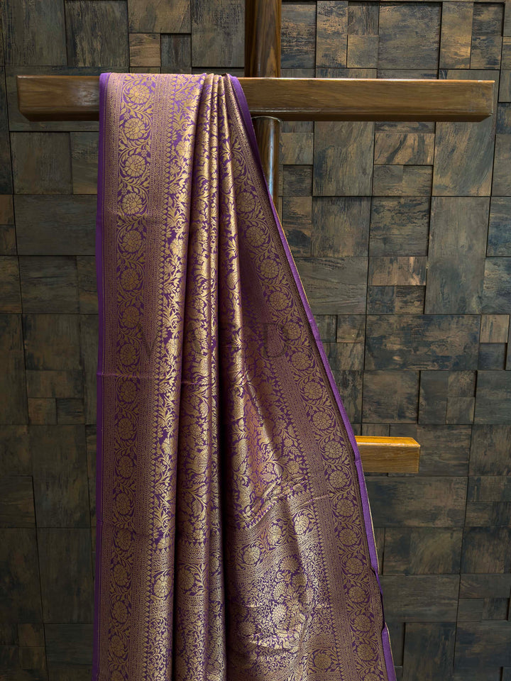 Close-up of purple saree pallu showing dense floral brocade in gold zari