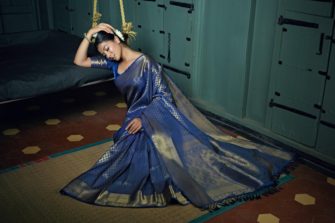 Side profile of model showcasing the pallu drape and overall texture.